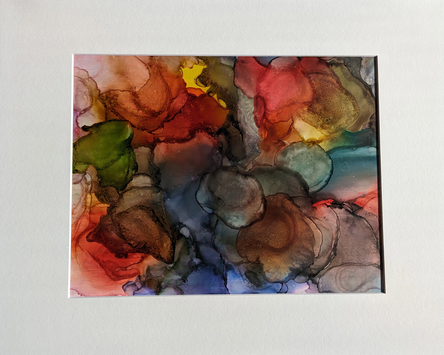 Digital mockup of Awakened Transformation framed in black hung on a white wall with a wooden shelf off to the side.