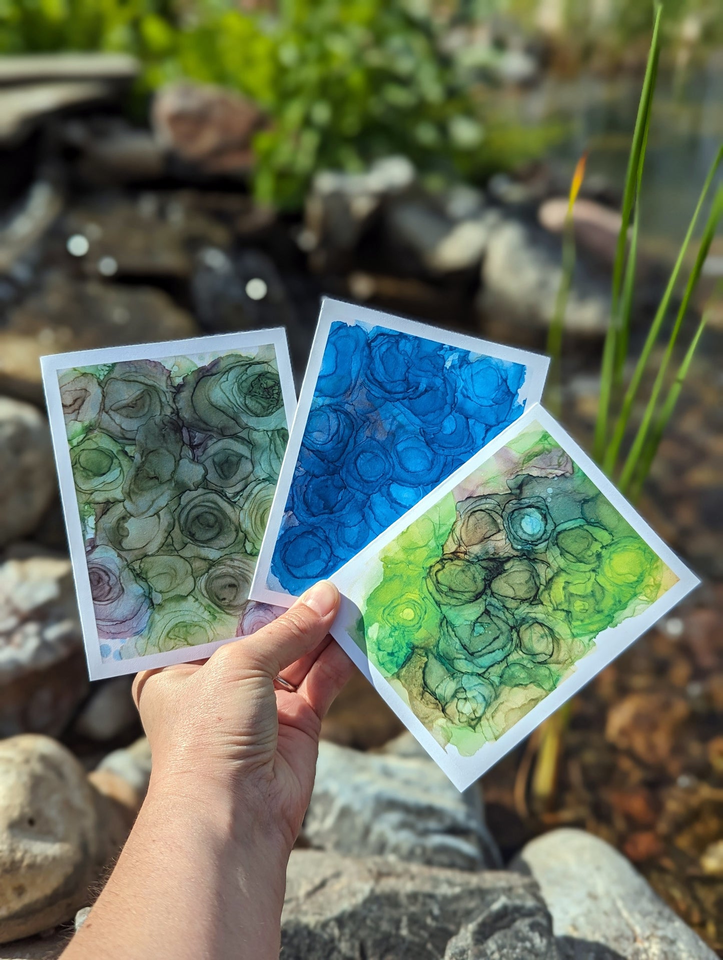 Six greeting cards overlapped in a line on top of wooden boards.
