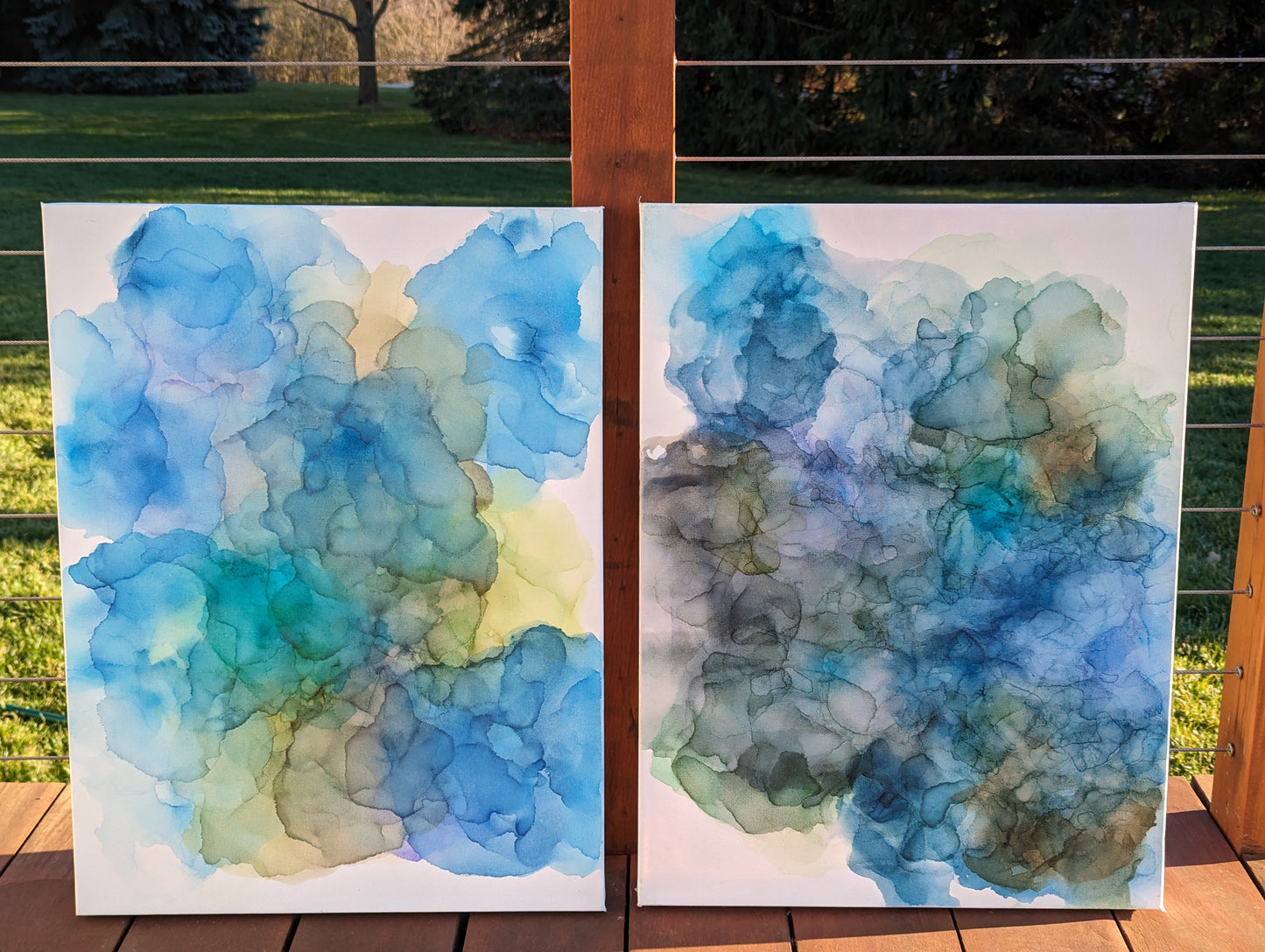 Two canvases shown side by side outdoors.