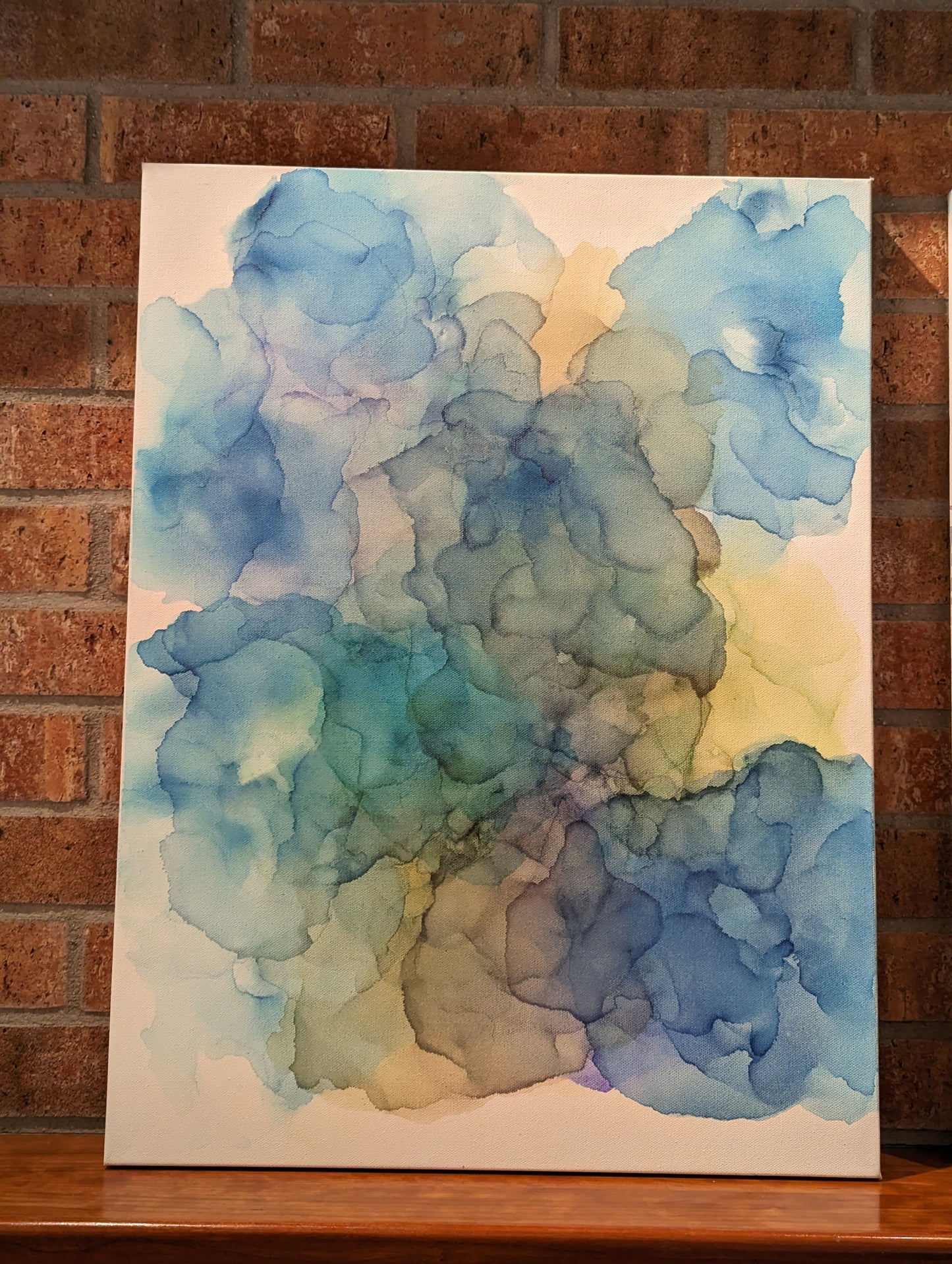 Left canvas shown indoors on a fireplace mantel.