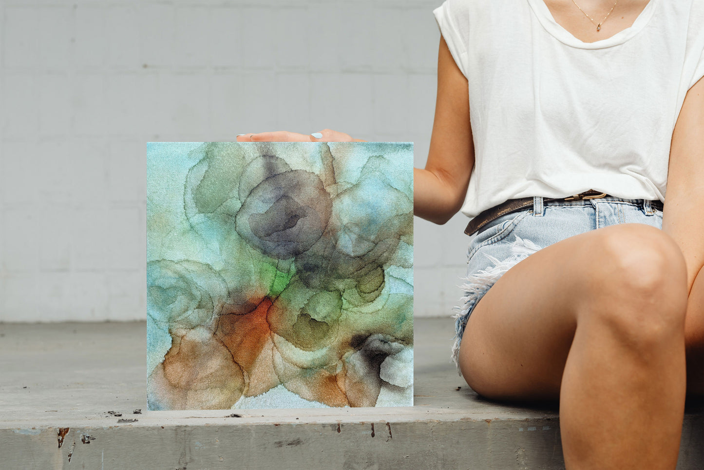 Digital mockup of Backwoods standing on concrete with a person sitting next it with their hand on it.