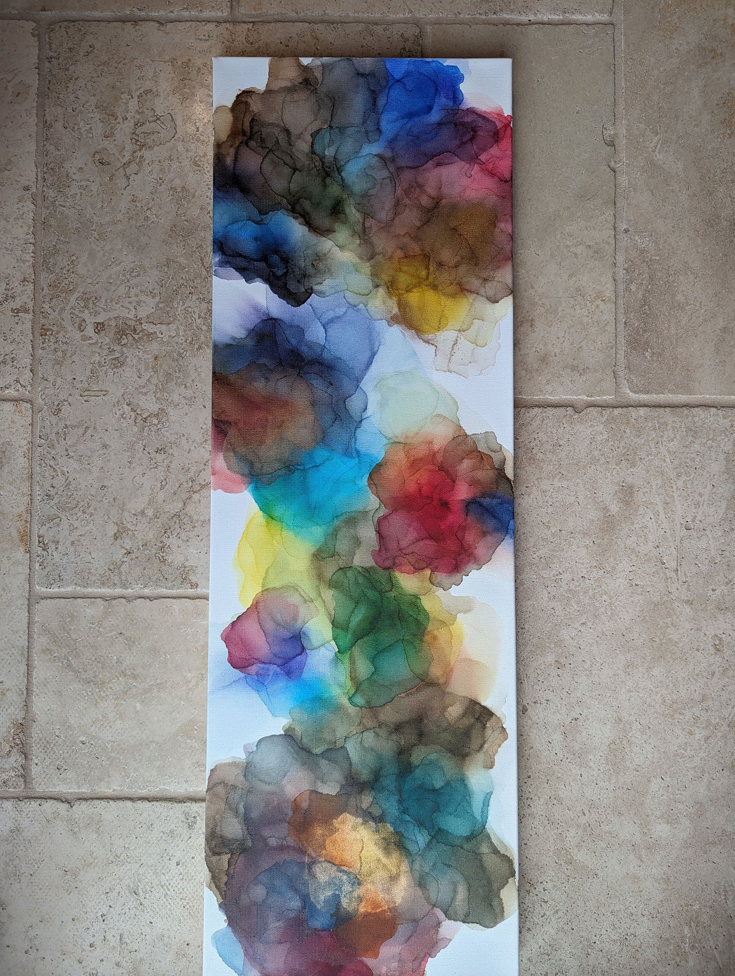 Expanding Boundaries laying flat on a stone tile floor background.