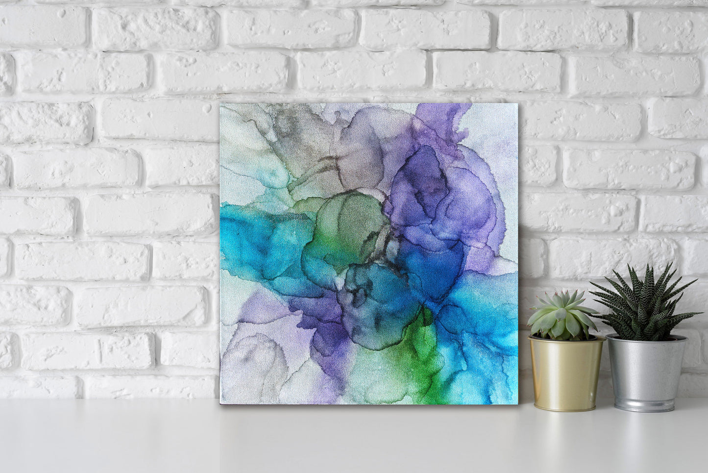 Digital mockup of Perseverance leaning against a white brick wall with succulents in small planters next to it.