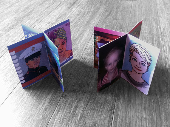 Two centerpieces standing on wooden boards showing photos and artist rednerings of each member of a military family to create a keepsake for the parent who is away from home.