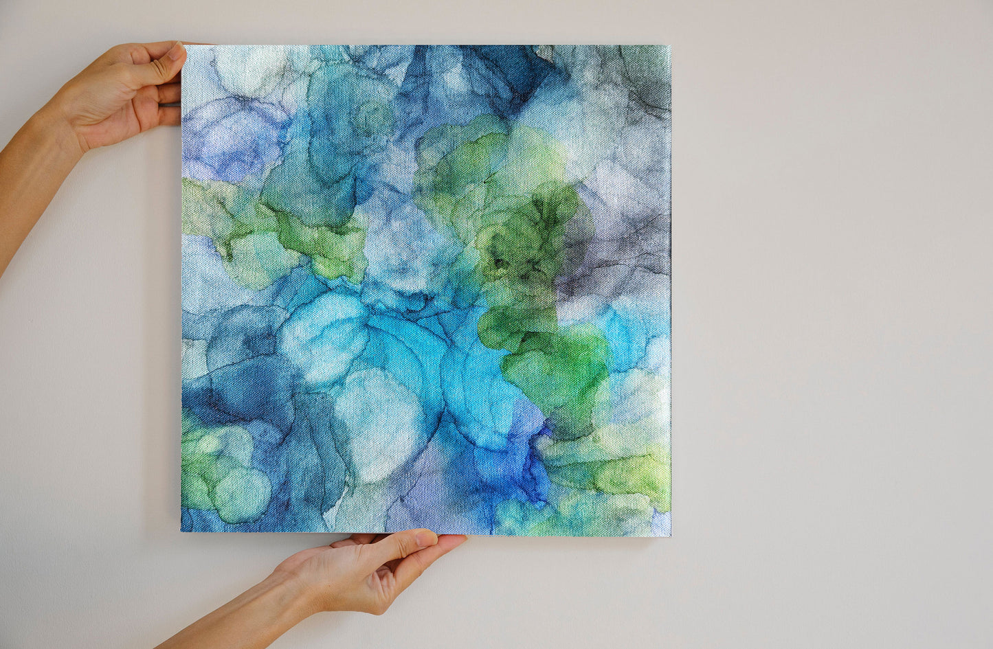 Digital mockup of hands holding Splash against a neutral background.