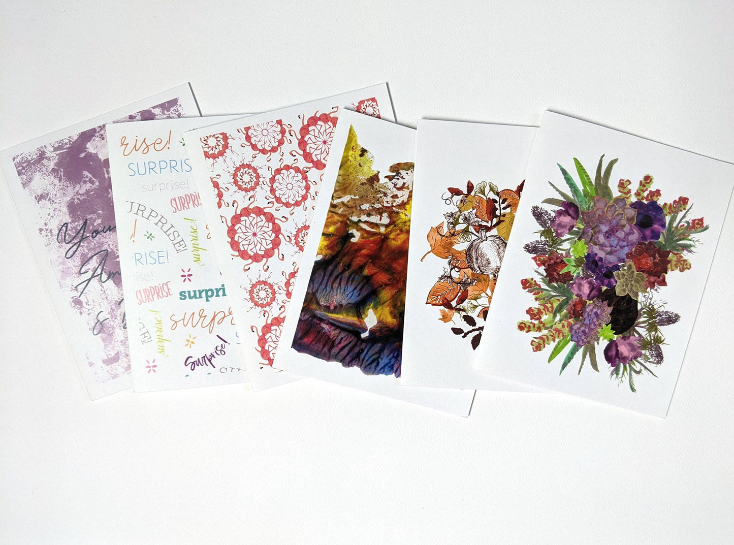 6 greeting cards overlapping in a line horizontally on a white background.