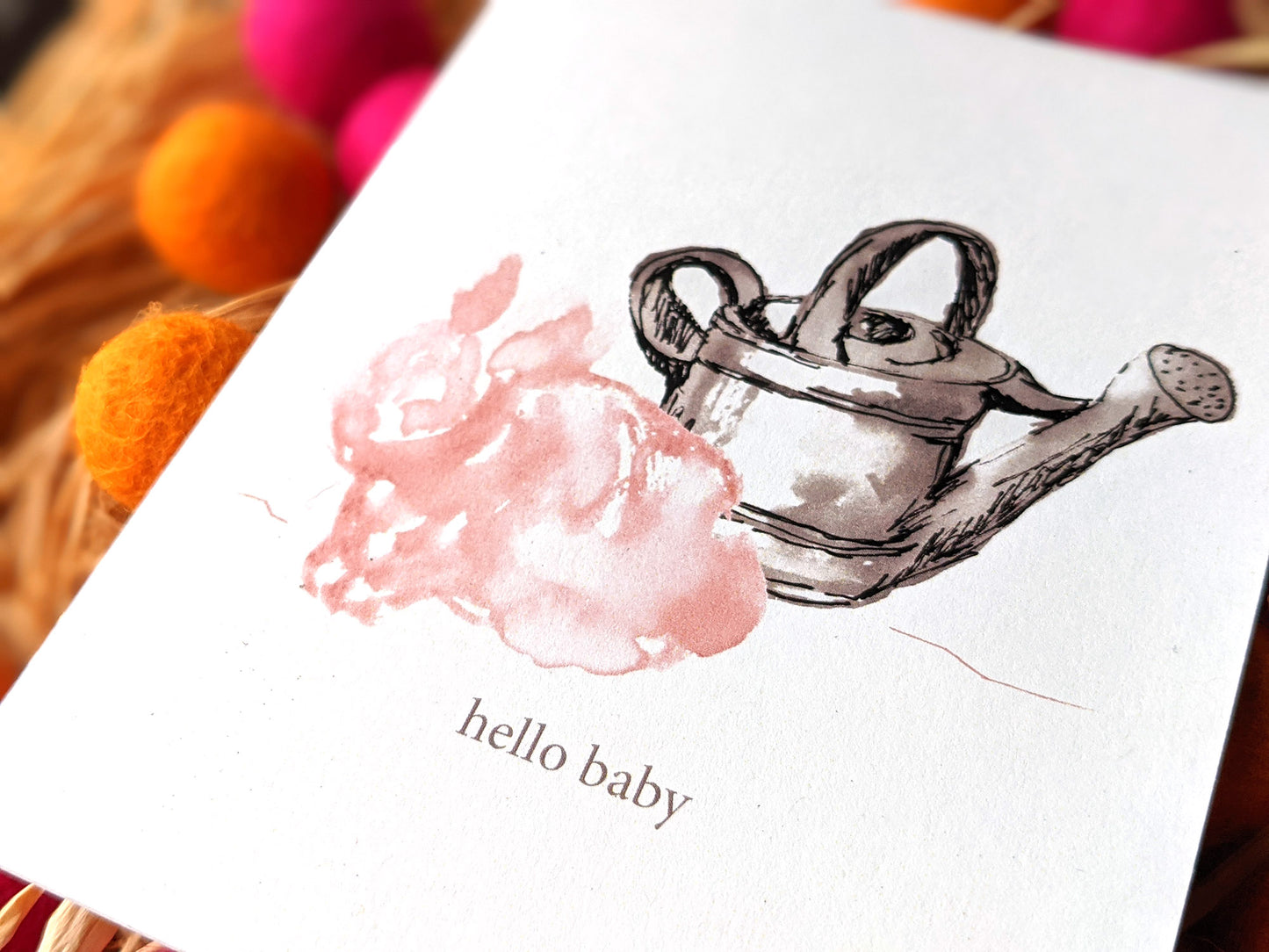Zoomed in detail of hand painted bunny and watering can.