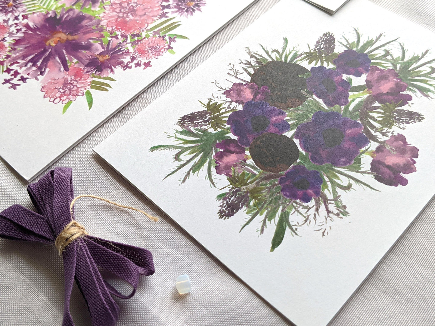 Angled view of greeting cards laying on a white surface.