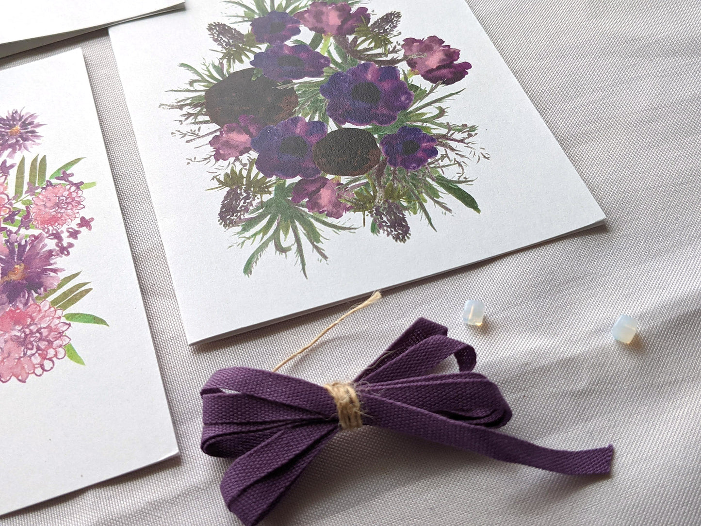 Angled view of greeting cards laying on a white surface.