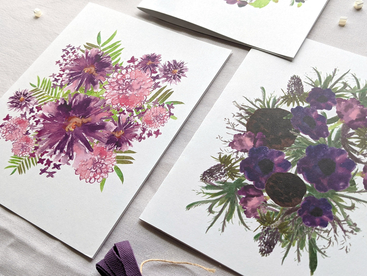 Angled view of greeting cards laying on a white surface.