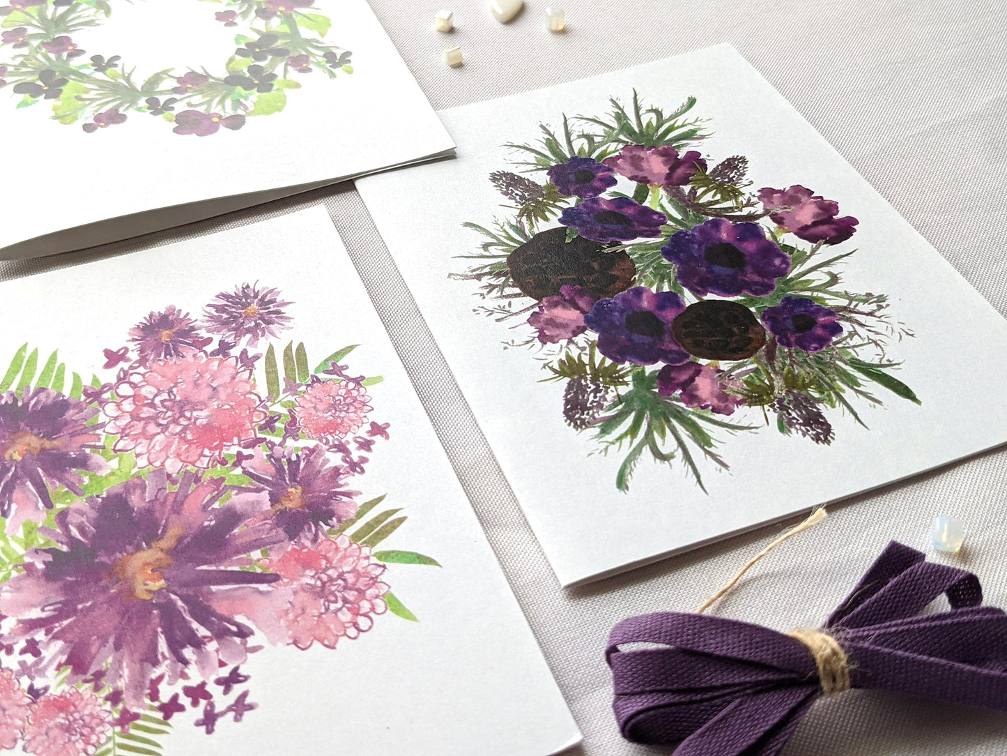 Angled view of greeting cards laying on a white surface.