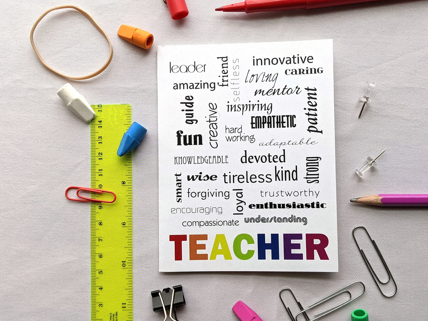 Greeting card on a white background surrounded by school supplies.