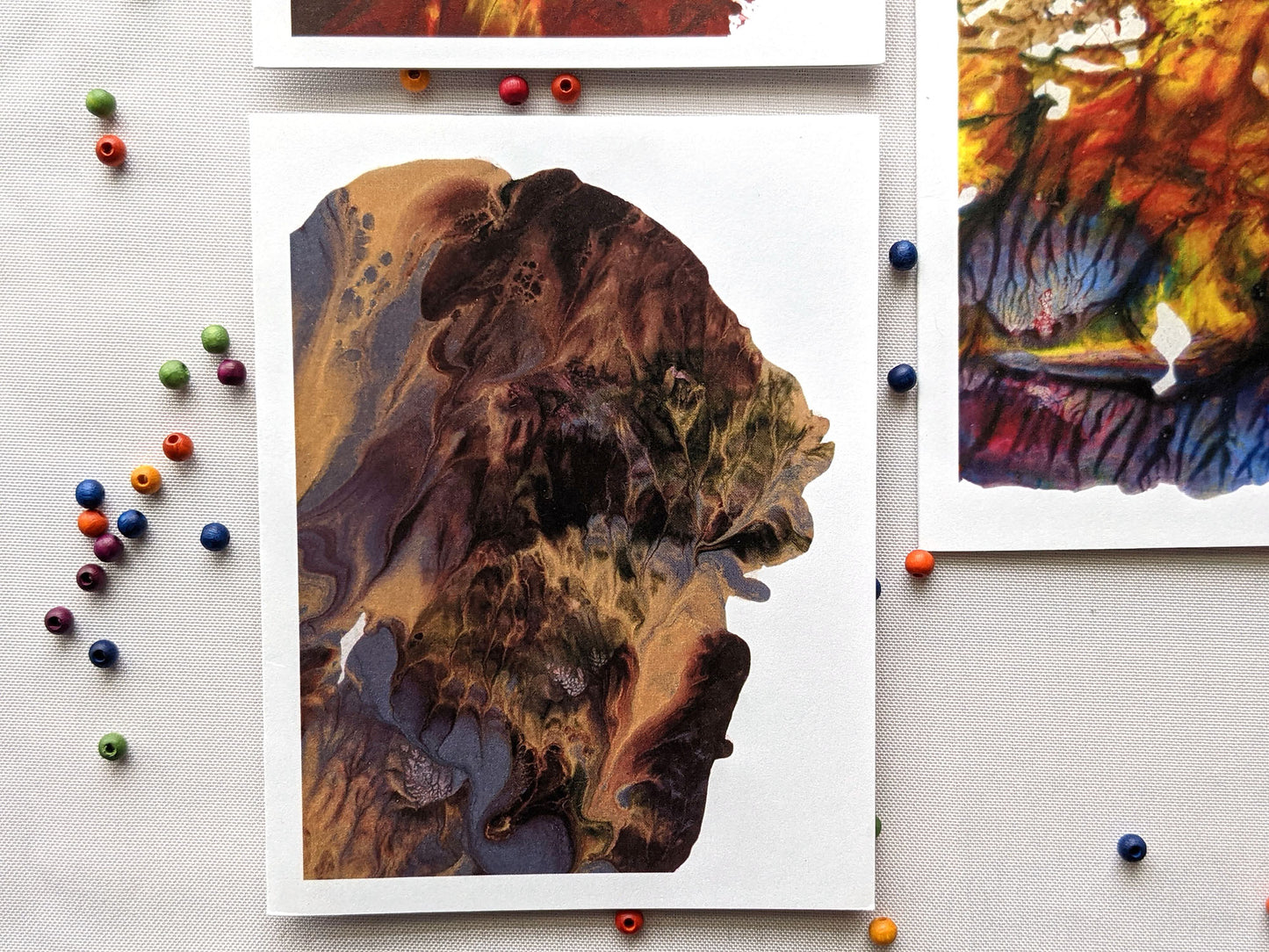 Greeting cards on a white background with colorful wooden beads.