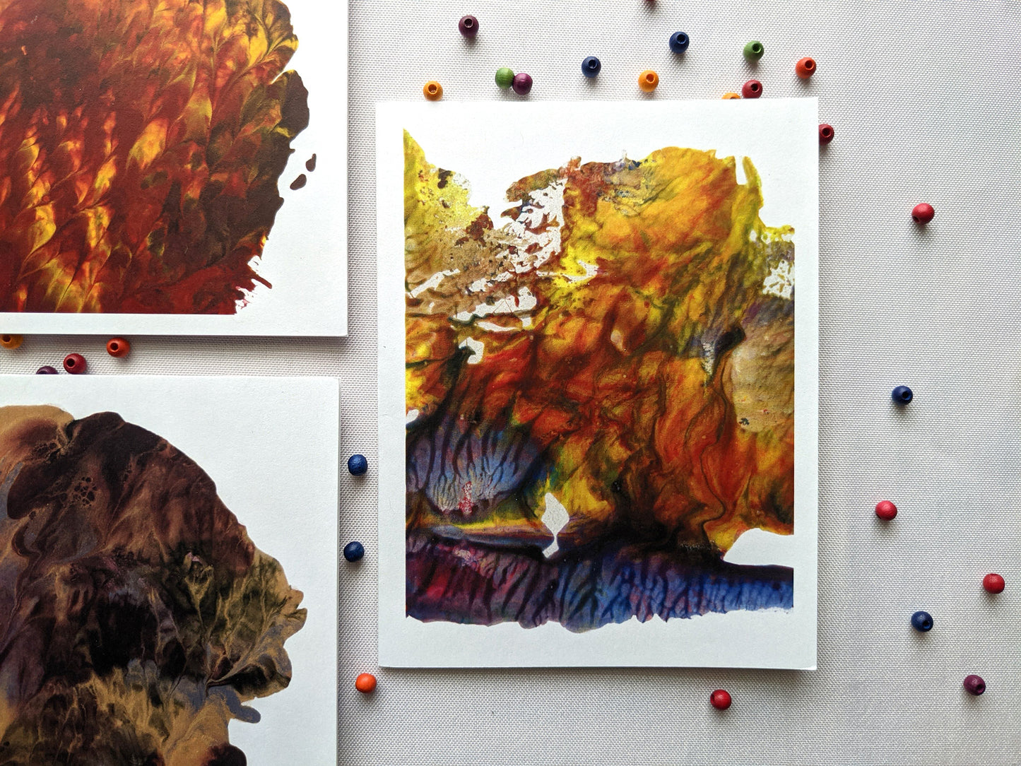 Greeting cards on a white background with colorful wooden beads.