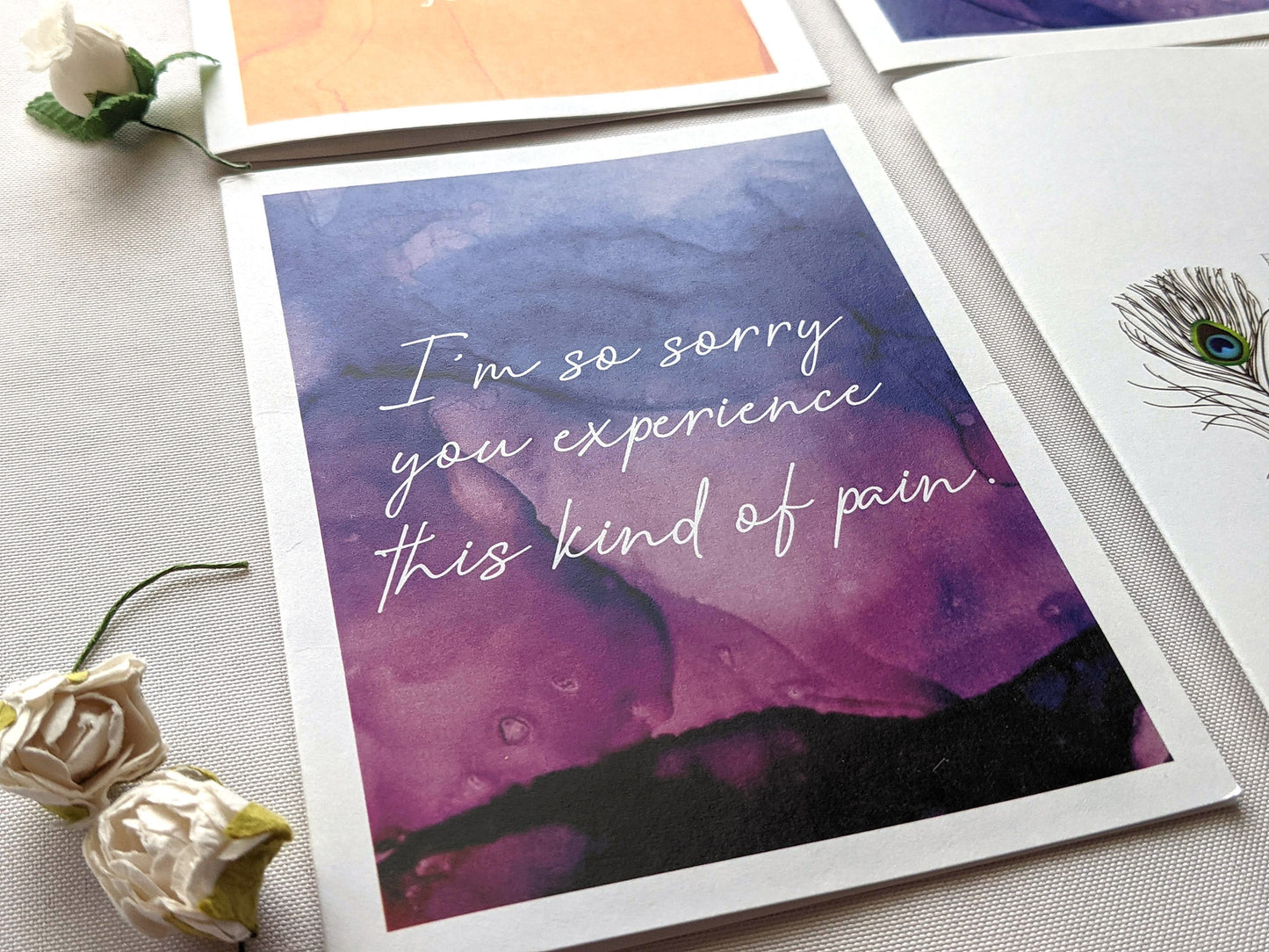 Greeting cards laying on a white background with faux flower buds.