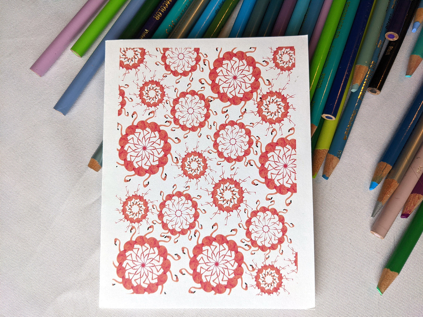 Greeting card laying on a pile of colored pencils.
