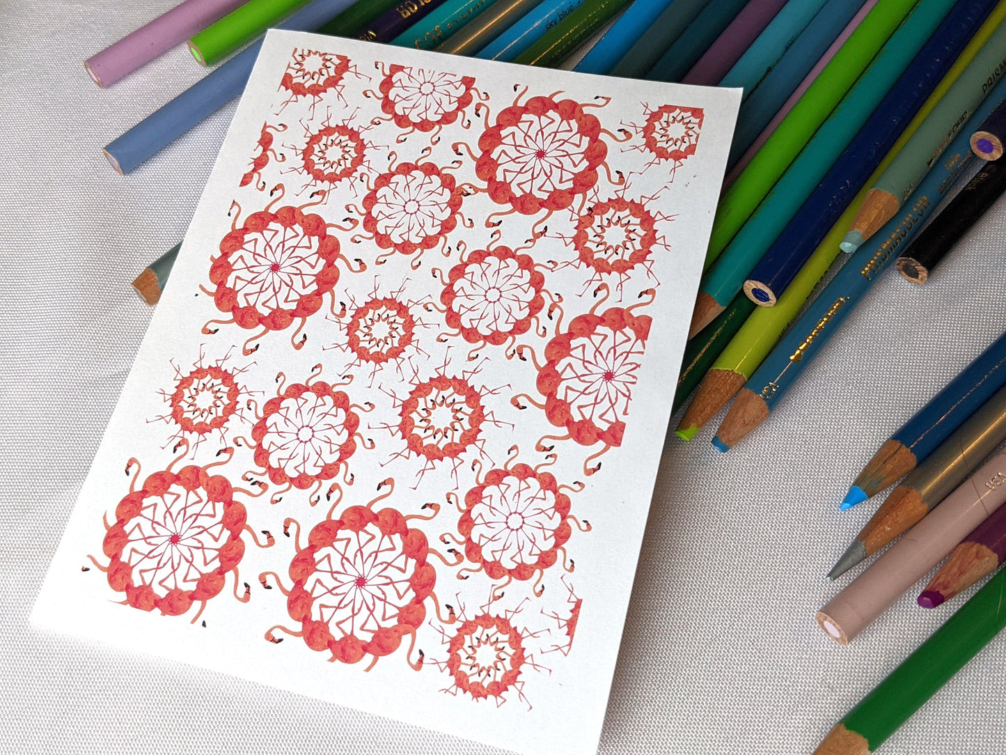 Greeting cards laying on a pile of colored pencils.