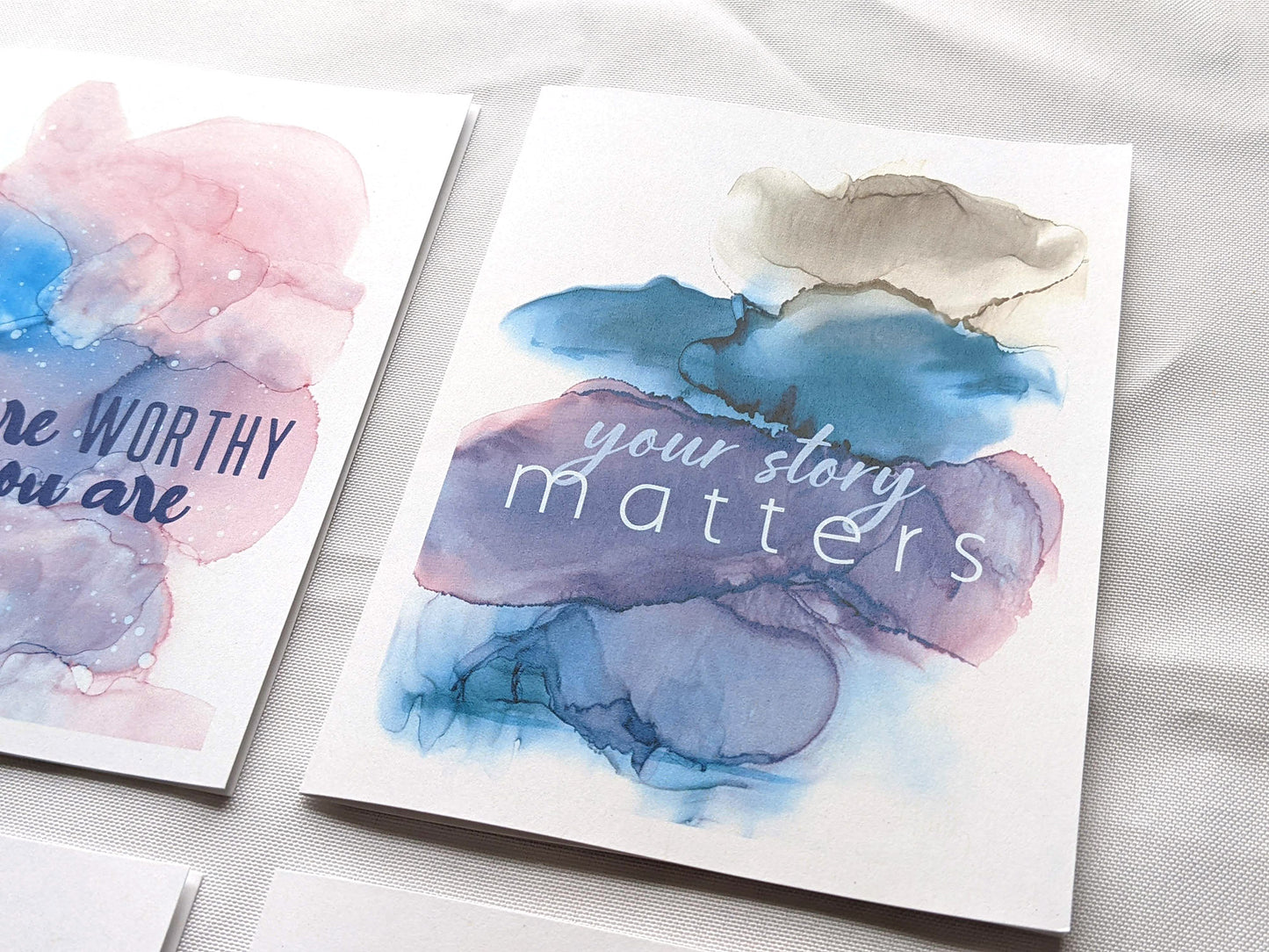 Angled view from above of greeting card next to others from the collection.