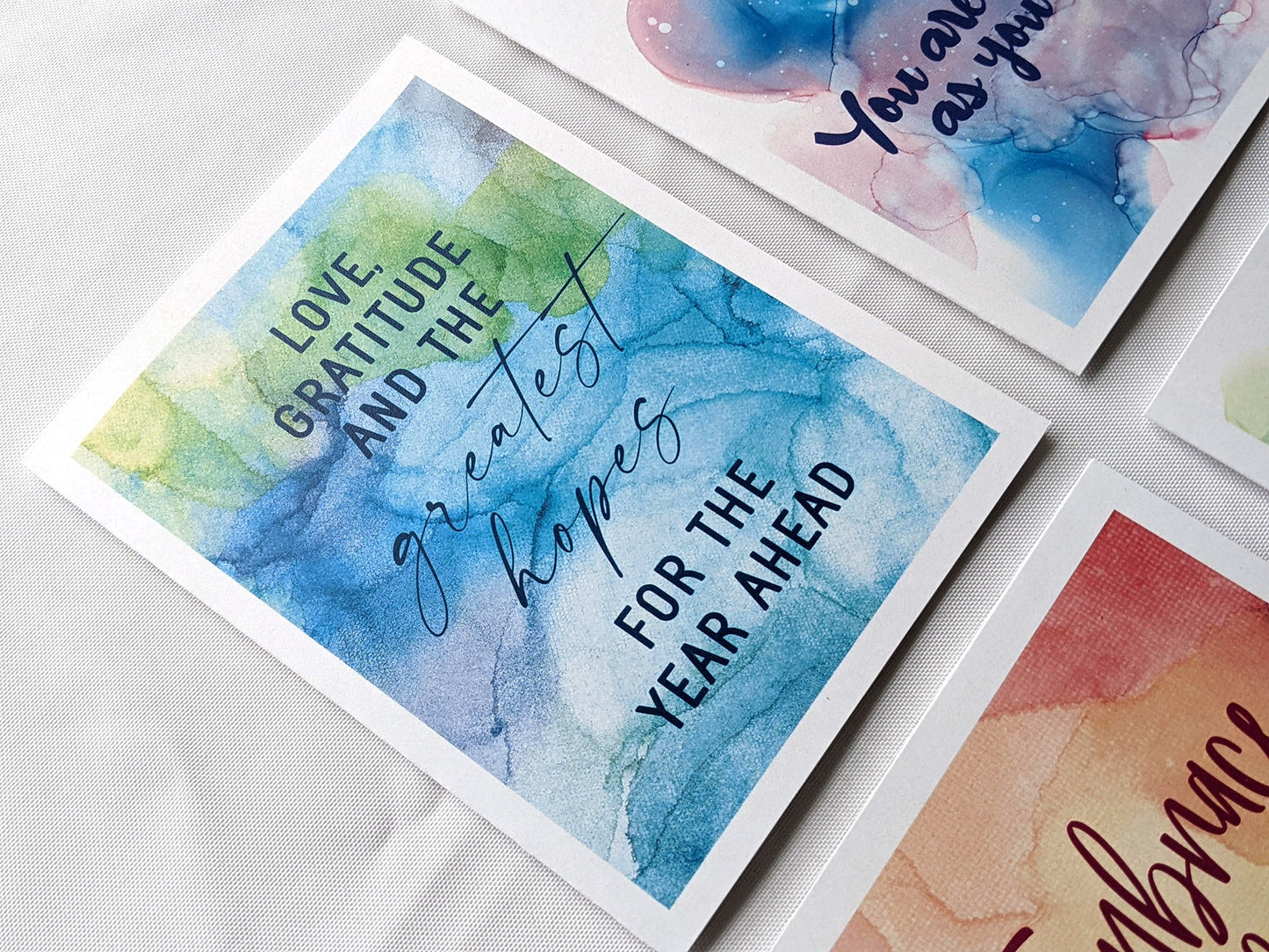 Angled view from above of greeting card next to others from the collection.