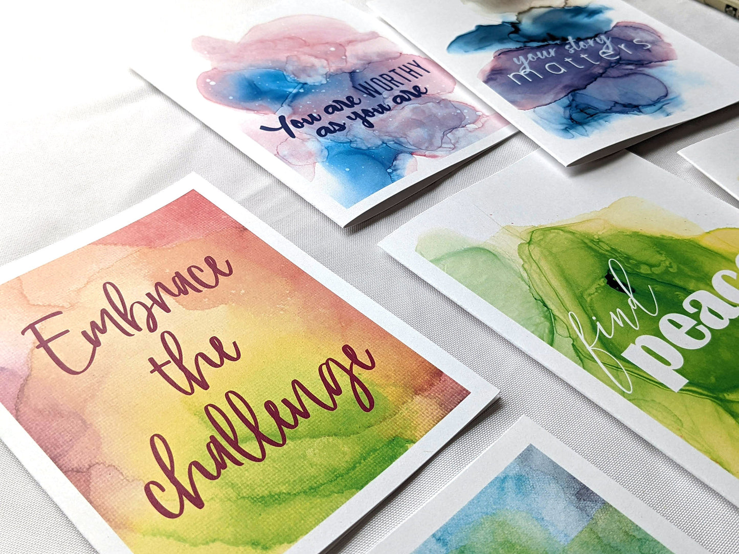 Angled view from above of greeting card next to others from the collection.