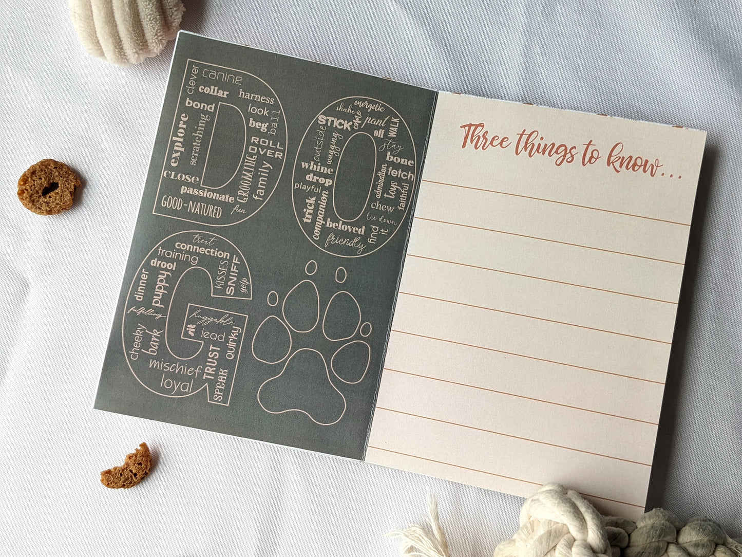 Flatlay of centerpiece showing the graphic design of two panels with dog toys and treats surrounding it.