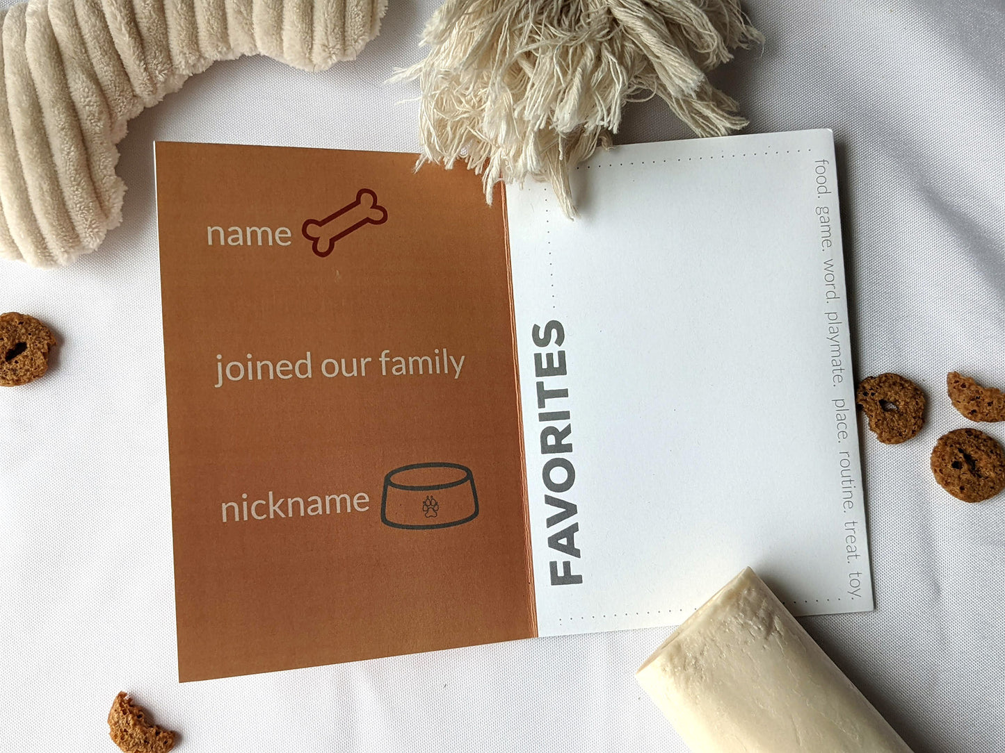 Flatlay of centerpiece showing the graphic design of two panels with dog toys and treats surrounding it.