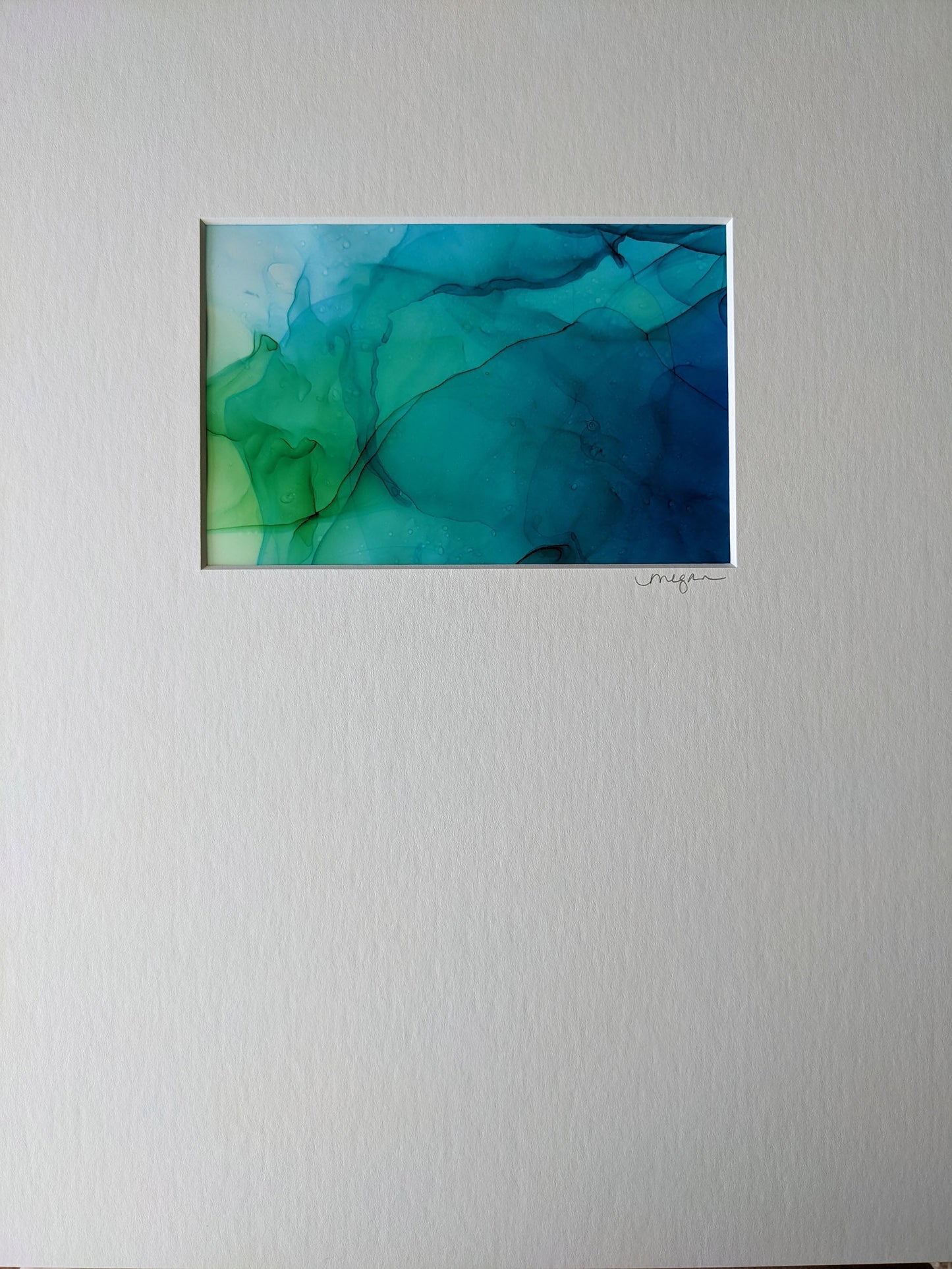Zoomed in view of two paintings framed in white.