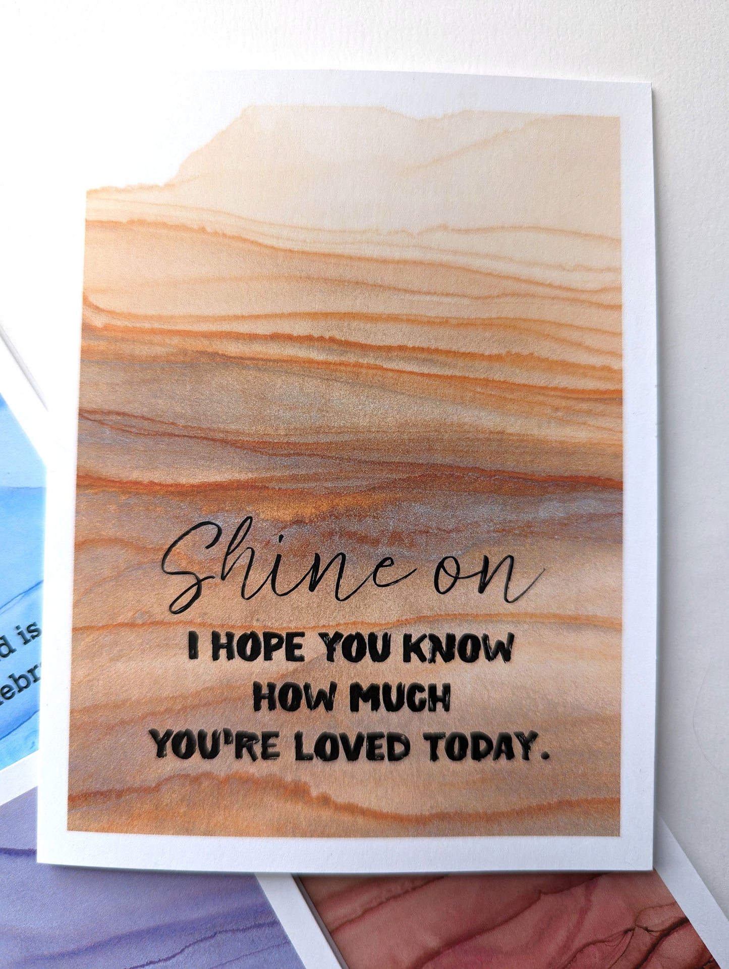 Lifestyle shot with close up of greeting card.