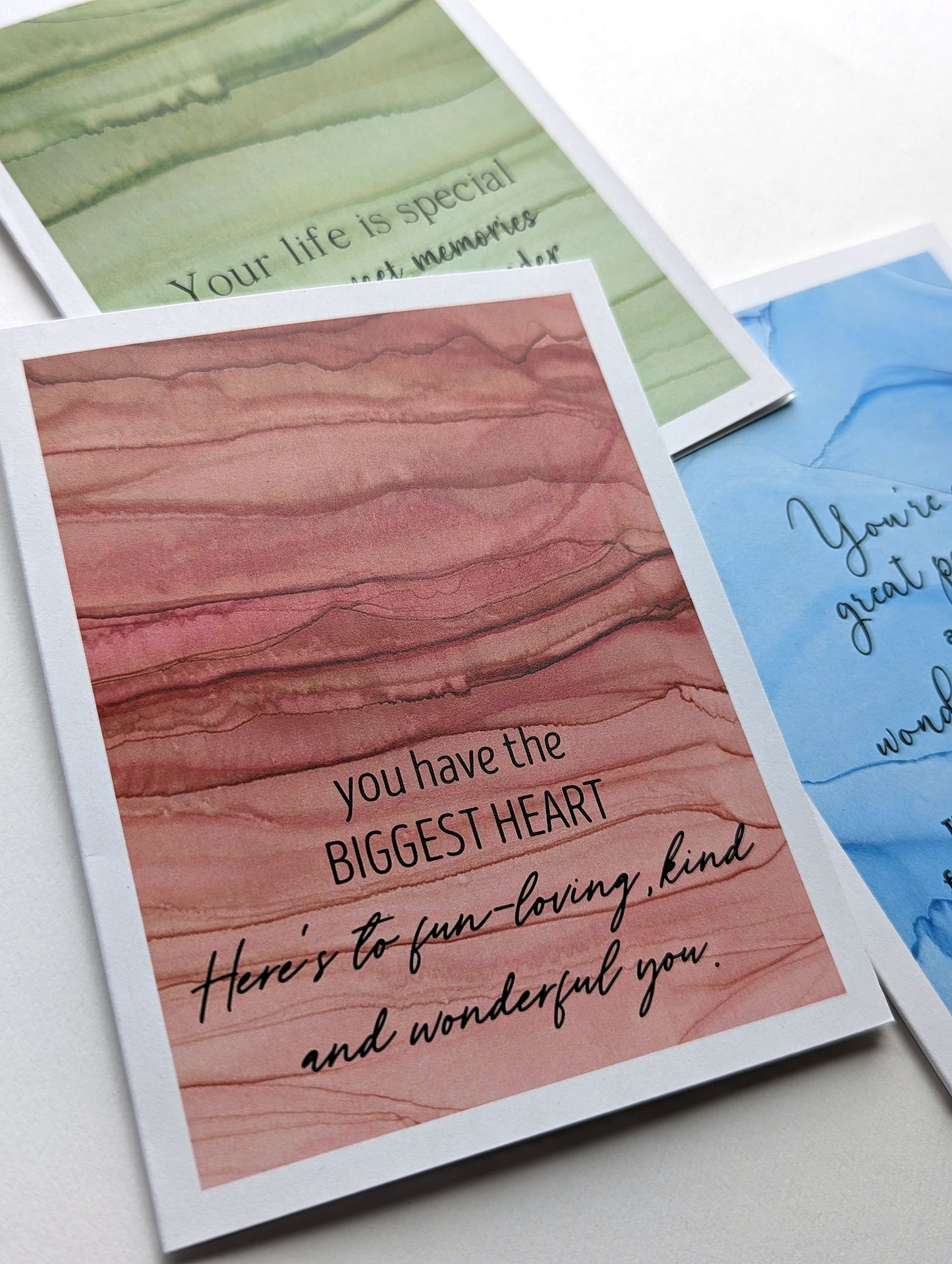 Lifestyle shot looking at the greeting card from above at an angle against a white background.