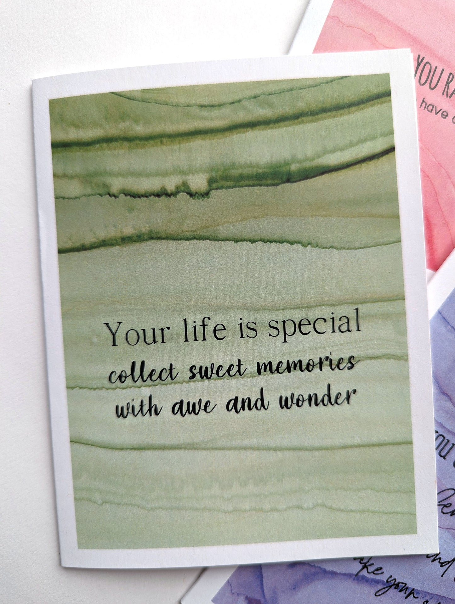 Lifestyle shot looking at the greeting card from above at an angle against a white background.