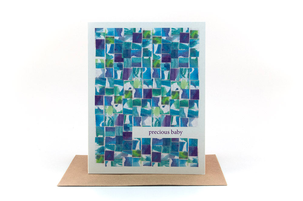 Greeting card standing upright on top of a kraft envelope against a white background.