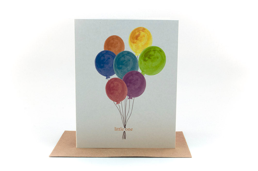 Greeting card standing upright on top of a kraft envelope against a white background.
