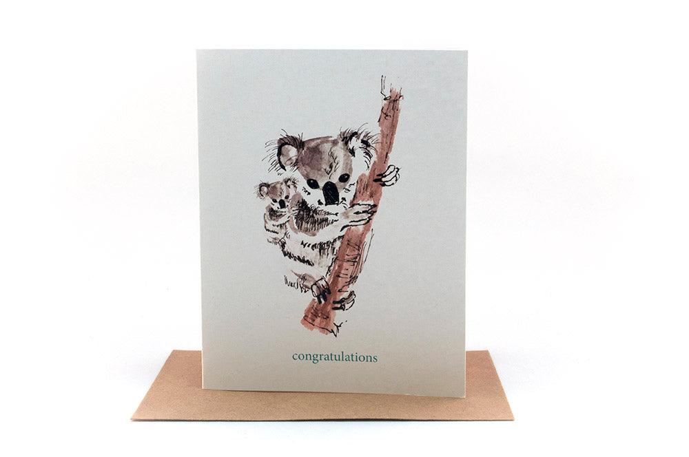 Greeting card standing upright on top of a kraft envelope against a white background.