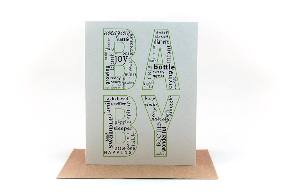 Greeting card standing upright on top of a kraft envelope against a white background.