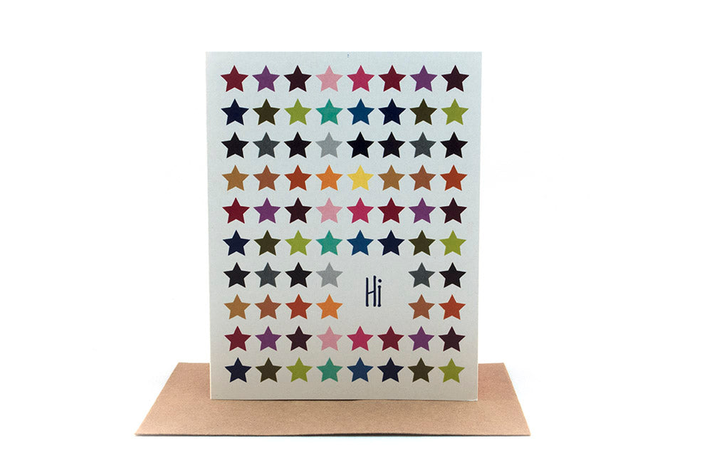 Greeting card standing upright on top of a kraft envelope against a white background.