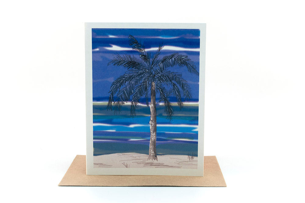 Greeting card standing upright on top of a kraft envelope against a white background.