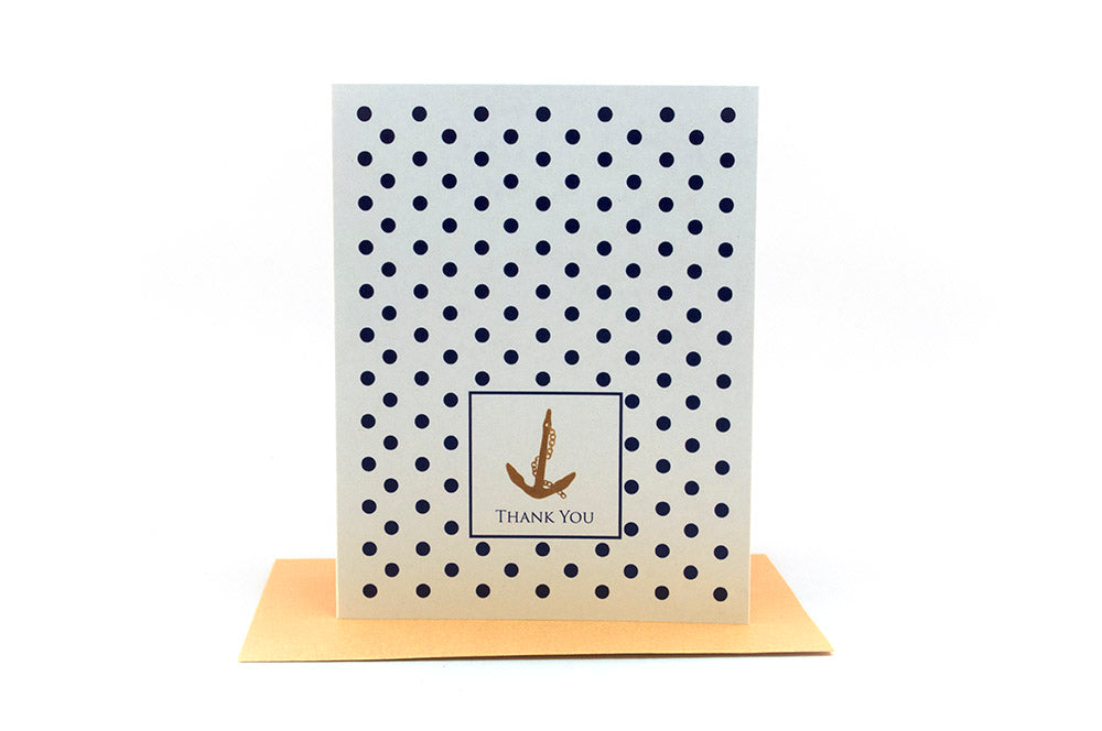 Greeting card standing upright on top of a colorful envelope against a white background.
