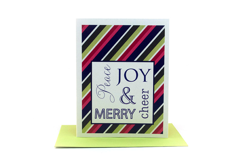 Greeting card standing upright on top of a colorful envelope against a white background.