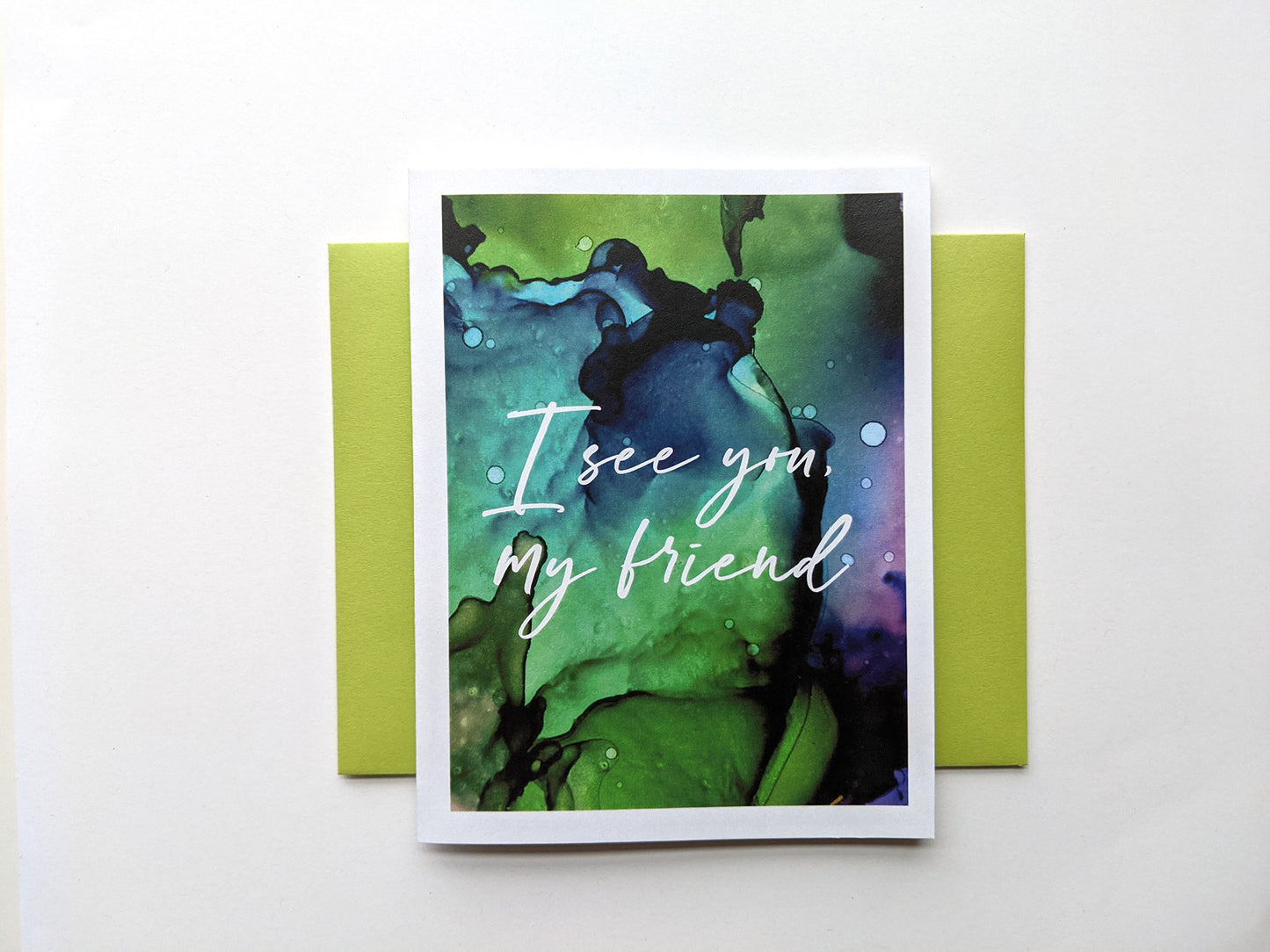 Greeting card with a colorful envelope on a white background.