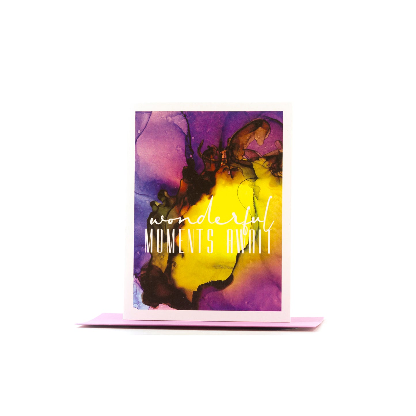 Greeting card standing upright on top of a colored envelope against a white background.