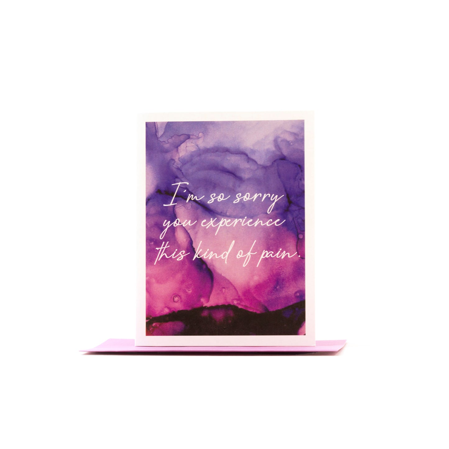 Greeting card standing upright on top of a colored envelope against a white background.