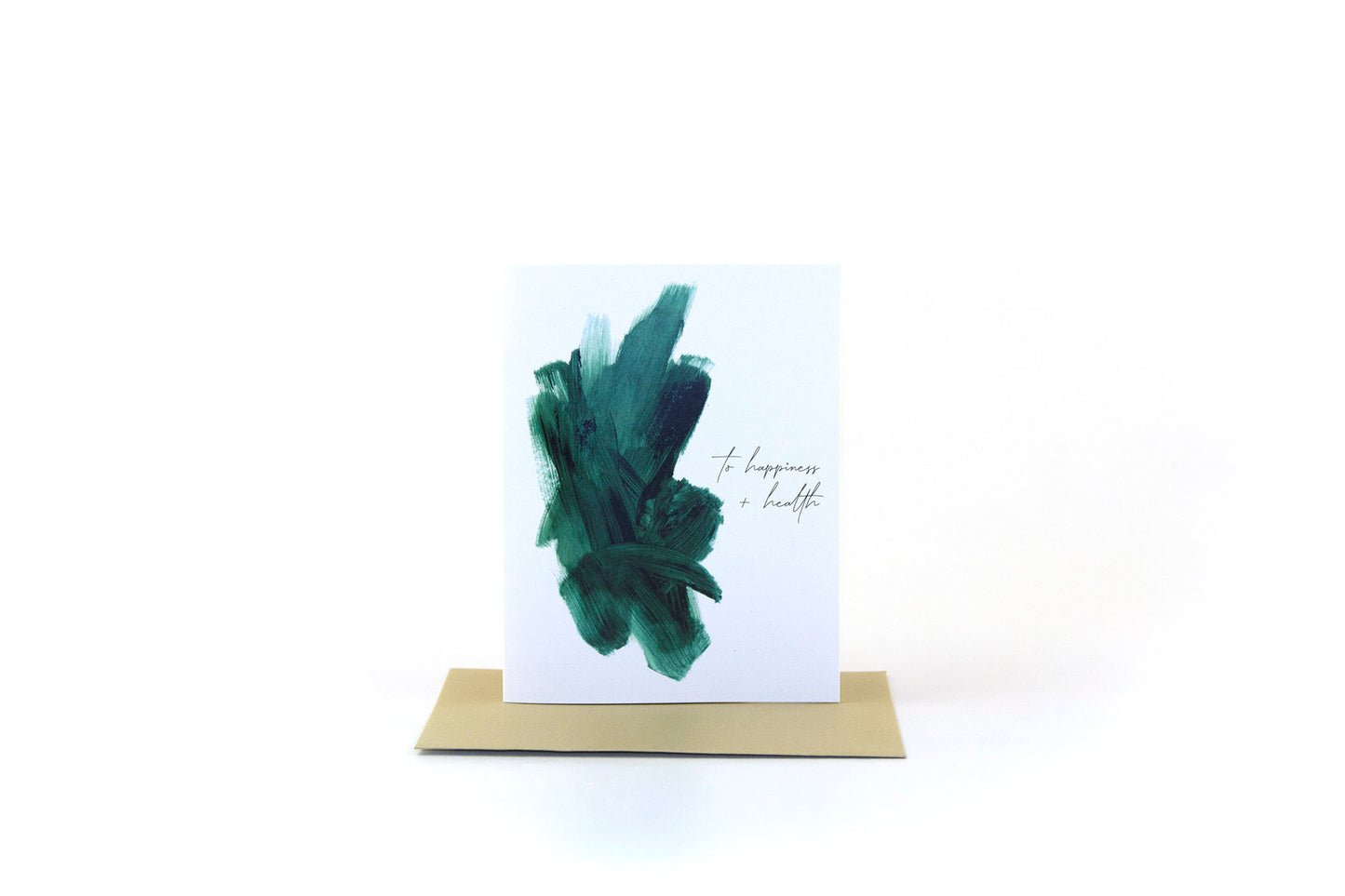 Greeting card standing upright on top of a colored envelope against a white background.