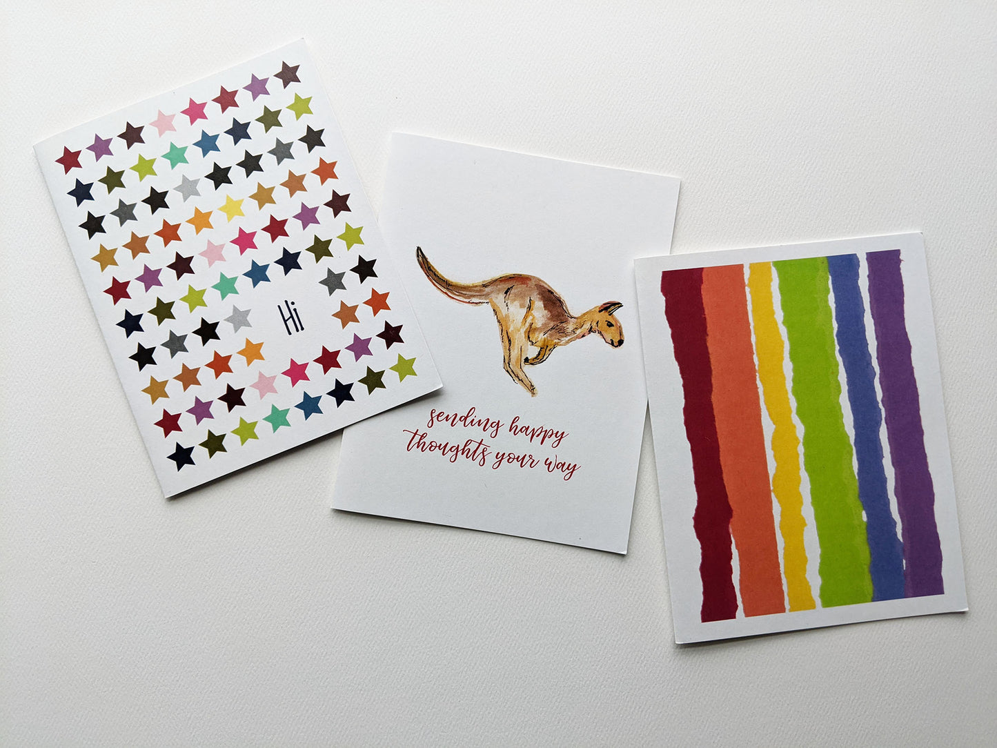 Three greeting cards overlapping in a row on a white background.