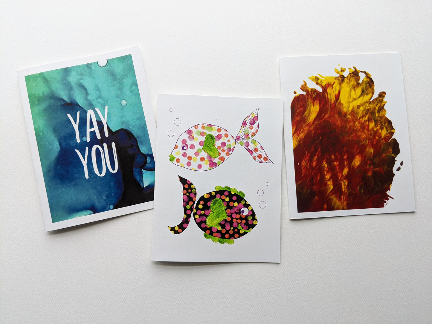 Three greeting cards overlapping in a row on a white background.