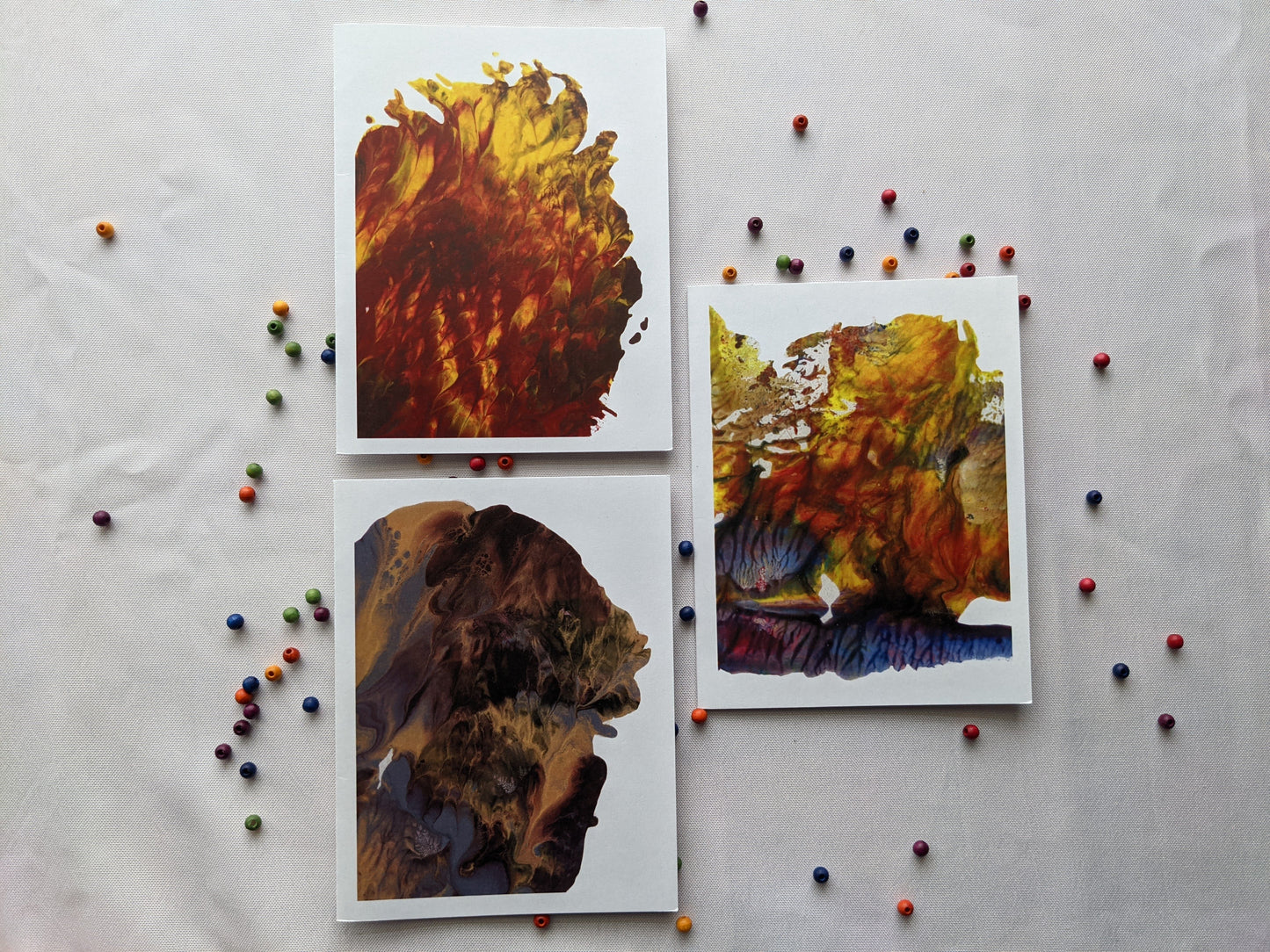 Greeting cards on a white background with colorful wooden beads.