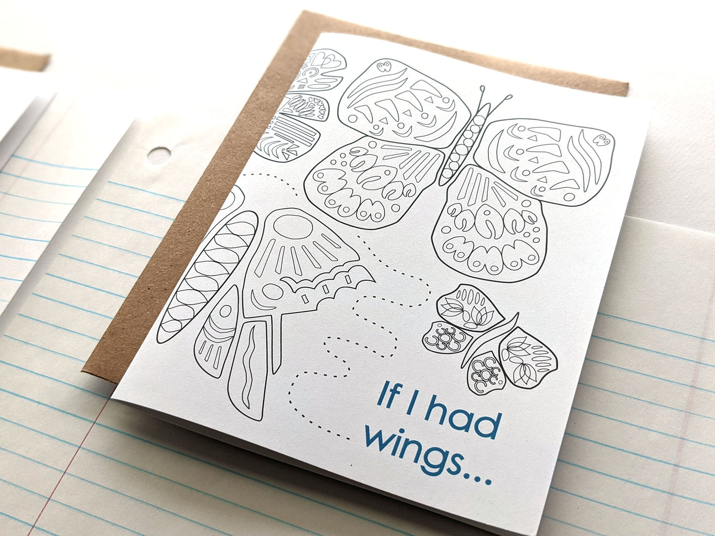 Angled view of greeting cards laying on lined notebook paper.