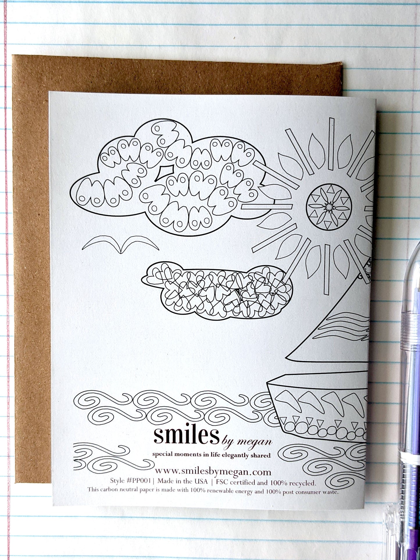 Back side of greeting card with a kraft envelope and lined notebook paper.
