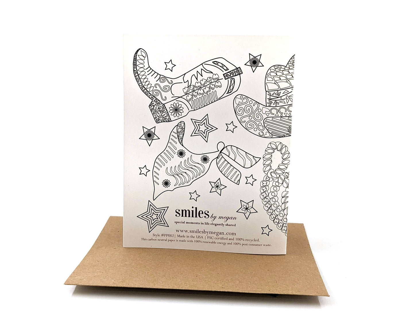 Back side of greeting card standing upright on top of a kraft envelope against a white background.