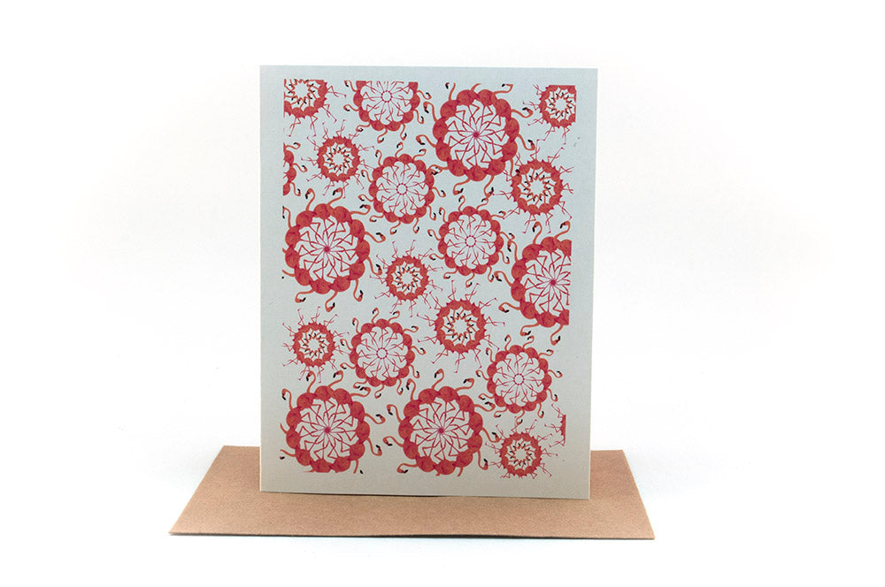 Greeting card standing upright on top of a kraft envelope against a white background.