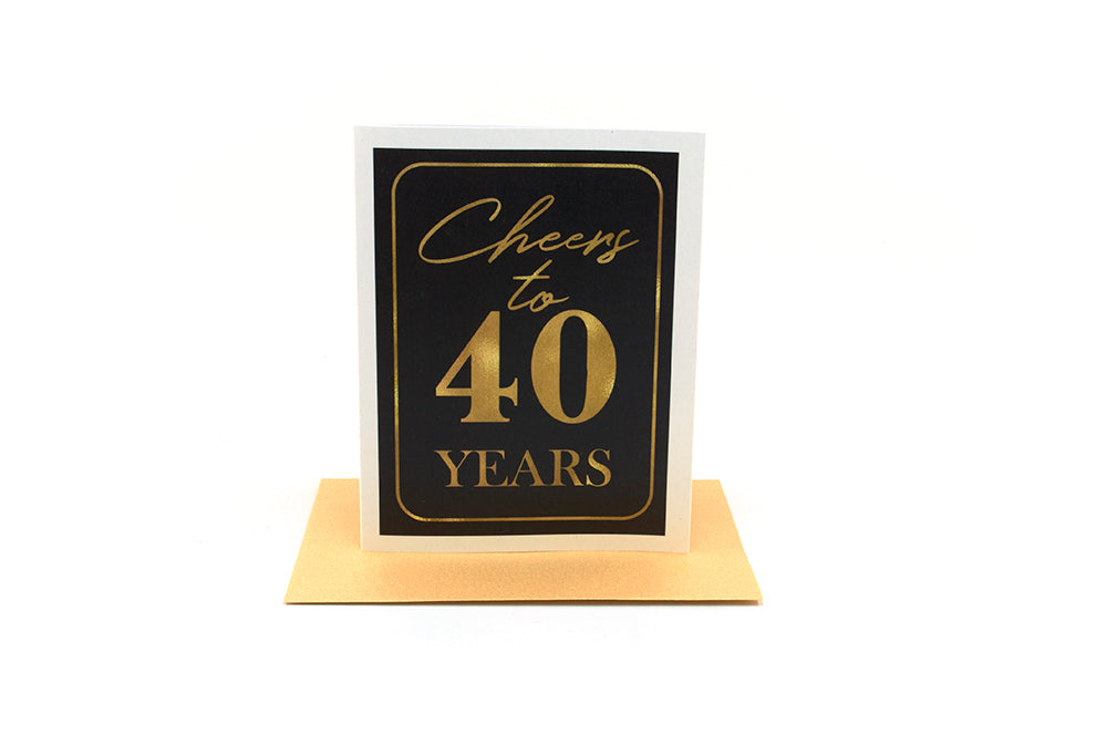 Greeting card standing upright on top of a colorful envelope against a white background.